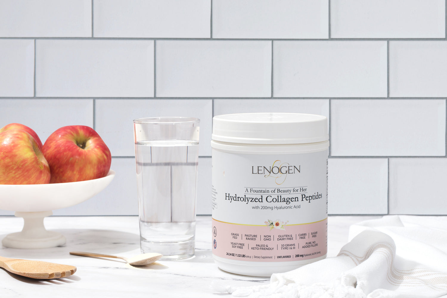 collagen peptides powder with hyaluronic acid supplement next to glass of water 